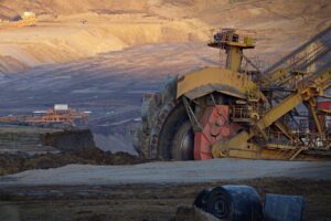 Massive yellow excavator mining operation.