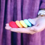 Vibrant rainbow cookies on an open hand symbolizing LGBT pride and diversity.