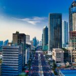 Stunning aerial view of Jakarta's modern skyline with bustling streets below.