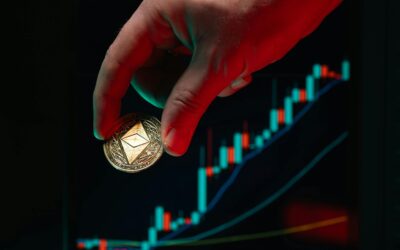 A hand holding an Ethereum coin against a rising stock market graph, symbolizing cryptocurrency growth.